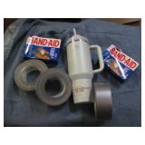 Stanley mug, duct tape and bandaids...