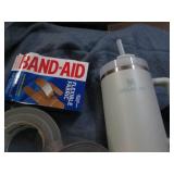 Stanley mug, duct tape and bandaids...