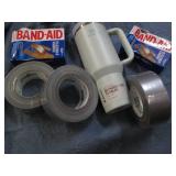 Stanley mug, duct tape and bandaids...