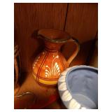 Bottom Shelf of Pottery