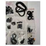 Collection of Black Gemstone and Glass Beads in Various Sizes and Shapes