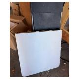 White folding table with black folding chair