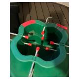 Christmas Tree Stand, Green Plastic With Center Hole And Eight Red-Capped Bolts