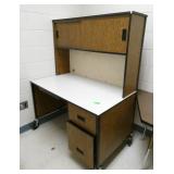 Rm 111B - Next room full - steel desk covered with wallpaper, table, stool, file cabinet
