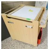 by Rm 110 - easel, play stand