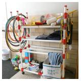 by Rm 108 - PVC rack with misc sporting goods