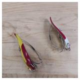 Two-piece lot of fish trap, weedless, snagless, spoon lures.