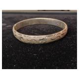 Sterling silver hinged bangle bracelet with a starburst and wave etched design.