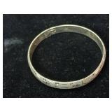 Sterling silver hinged bangle bracelet with a starburst and wave etched design.