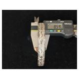 Sterling silver hinged bangle bracelet with a starburst and wave etched design.