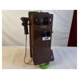 Antique Western Electric oak cased wall-mounted crank telephone, commonly used in the early 20th century