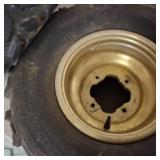 Set of used ATV tires mounted on gold-colored rims