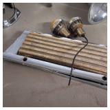 Lot of boat parts, primarily chrome accessories including spotlights, navigation lights, and a horn