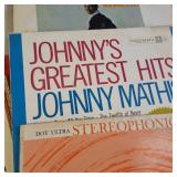 A  large collection of vintage vinyl records from artists like Johnny Mathis, Billy Vaughn, Ray Conniff, and Dean Martin