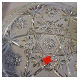 Collection of vintage porcelain and glass dishes, featuring various floral patterns, gilded rims, and crystal designs.