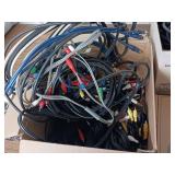 Large collection of various electronic cables, connectors, and a boxed electronic devices