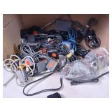 Collection of vintage video game accessories and plug-and-play consoles including PlayStation 2 and PlayStation 1 controllers