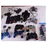 Collection of vintage video game accessories and plug-and-play consoles including PlayStation 2 and PlayStation 1 controllers