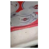 Coca Cola Dishes , and unopened tin with railroad toy on top Coca Cola Dishes , and unopened tin with railroad toy on top