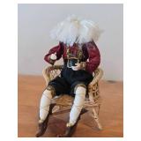 Santa Claus Sitting on a Wicker Chair Figurine by Band Creations