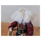 Santa Claus Sitting on a Wicker Chair Figurine by Band Creations