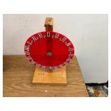 Number wheel spinner on wooden base