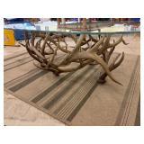 Glass Top Coffee table with authentic antler base. Buck scene etching on top