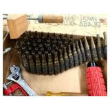 Assortment of garage items including spent shells belt