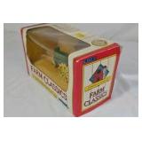 Diecast John Deere Model A tractor features a green body with yellow spoked wheels and detailed engine components. Packaged in the original window box labeled Farm Classics by ERTL. Classic farm toy r