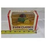 Diecast John Deere Model A tractor features a green body with yellow spoked wheels and detailed engine components. Packaged in the original window box labeled Farm Classics by ERTL. Classic farm toy r
