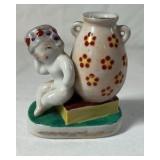 Occupied Japan Porcelain Figurine – Cherub Leaning on Vase with Flowers