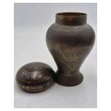 Bronze jar with rounded body and domed lid.
