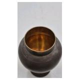 Bronze jar with rounded body and domed lid.