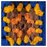 Vintage Crocheted Granny Square Afghan – Multicolor Floral Motifs on Navy Ground