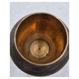 Bronze jar with rounded body and domed lid.