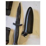 Lot of three knives including Smith & Wesson H.R.T., two other knives with paracord-wrapped handles, and sheaths