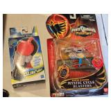 Box of Toy Cars and Power Rangers Items including Black & Decker Toy Plane, Beyblade Slingshot, Power Rangers Mystic Cycle Blasters, and Matchbox Cars