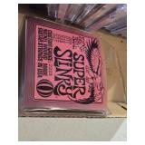 Ernie Ball Super Slinky Guitar Strings and Music CD Collection featuring artists like Kenny G, Andrea Bocelli, and Santana.