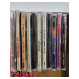 Ernie Ball Super Slinky Guitar Strings and Music CD Collection featuring artists like Kenny G, Andrea Bocelli, and Santana.