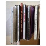 Ernie Ball Super Slinky Guitar Strings and Music CD Collection featuring artists like Kenny G, Andrea Bocelli, and Santana.