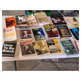 Lot of Books on History, Culture, and Social Issues including "How to Be Black" by Baratunde Thurston, "Deaf in America" by Carol Padden and Tom Humphries, and "Pity the Nation" by Robert Fisk