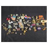 Lot of Assorted Brooches and Pins featuring themes like Operation Desert Storm, sports teams, and novelty designs.