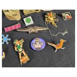 Lot of Assorted Brooches and Pins featuring themes like Operation Desert Storm, sports teams, and novelty designs.