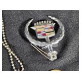 Assorted Vintage Collectibles including Liberty Bell Belt Buckle, Cadillac Emblem, and Leather Key Pouches