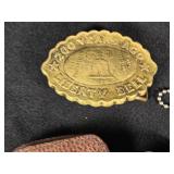 Assorted Vintage Collectibles including Liberty Bell Belt Buckle, Cadillac Emblem, and Leather Key Pouches