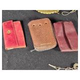 Assorted Vintage Collectibles including Liberty Bell Belt Buckle, Cadillac Emblem, and Leather Key Pouches