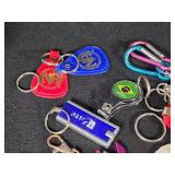 Large Lot of Assorted Keychains and Accessories featuring unique designs such as a beaded lizard, miniature license plates, and themed items from Las Vegas.