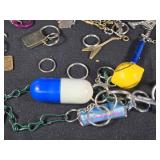 Large Lot of Assorted Keychains and Accessories featuring unique designs such as a beaded lizard, miniature license plates, and themed items from Las Vegas.