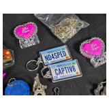 Large Lot of Assorted Keychains and Accessories featuring unique designs such as a beaded lizard, miniature license plates, and themed items from Las Vegas.