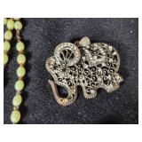 Lot of Costume Jewelry including Beaded Necklace, Gold Brooch, and Decorative Belt
